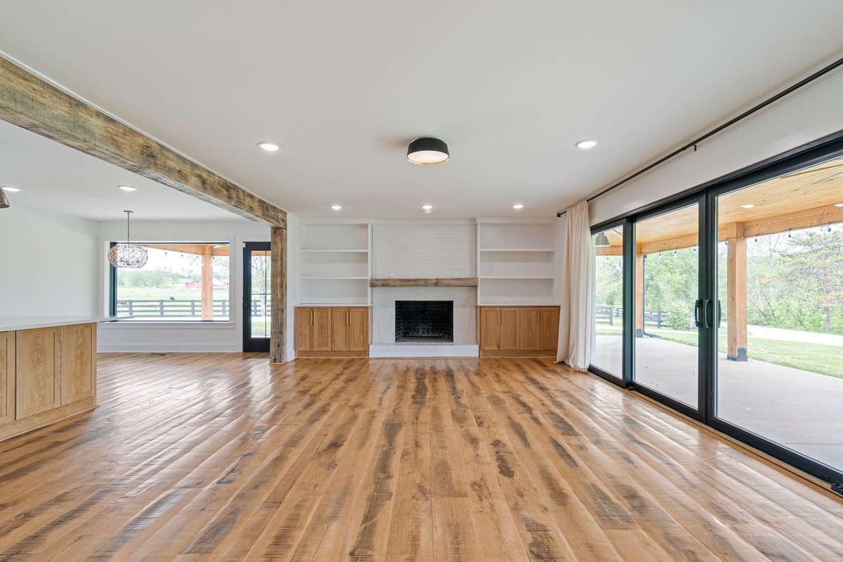 Large Living room, fireplace, oversized sliding doors bringing outside to your indoor environment.
