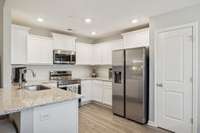 Kitchen with granite counter tops.