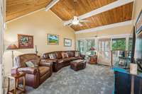 Vaulted ceiling Great Room/Living Room with door going out to screened in porch.