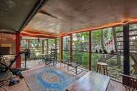 Another view of screened in porch that is is approximately 25x11 that overlooks fenced back yard.