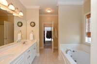 primary suite has double sinks, whirlpool tub and walk in shower