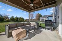 If you aren't in love with this home already, the backyard area is going to grab your heart, starting with this covered patio area off the eat-in area of the kitchen, complete with a decorative beadboard ceiling and a fan.