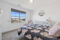 Bedroom three is tucked at the end of the hallway, offering privacy and a view from above the living room and front porch on the front of the home.