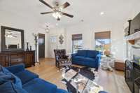 Accented by a stylish hanging chandelier, the entry opens seamlessly into the living room, where a ceiling fan keeps the space comfortable year-round.