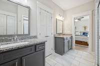 Behind those double doors in the primary bathroom is a grand walk-in closet that measures approximately 7' x 11'.  So much space! The linen closet (in the reflection) and commode flank the shower.