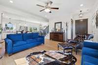 Measuring approximately 15' x 16', the living room’s nearly square layout offers versatile options for furniture arrangement and comfortable living, and it flows seamlessly into the kitchen area.