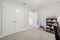 Double doors to the bedroom closet showcase the Craftsman three-panel style that complements all the interior doors in the home.