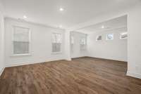 Primary Bedroom (downstairs) upgraded to Revwood Flooring & with a sitting room right off of it! Actual Home