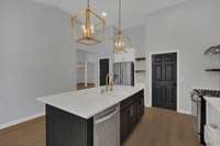 This stunning kitchen combines modern design with everyday functionality. With a spacious center island, abundant  quartz counter space and a white subway tile backsplash it's perfect for cooking, entertaining or gathering with family and friends.