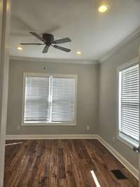 Bedroom 2 in this lovely home with bright windows and Levolar blinds.