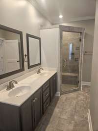 Double vanities in primary en suite, and just  look at that amazing shower!