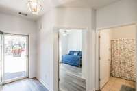 The foyer, secondary bedroom, and hall bathroom.