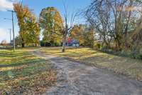 This over 1 acre lot has a private drive winding through a tree lined yard