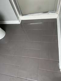 beautiful soft grey tile floor in both bathrooms, this bathroom boasts a walk in shower