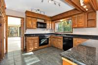Kitchen- tile, granite countertop, range/oven, dishwasher, microwave