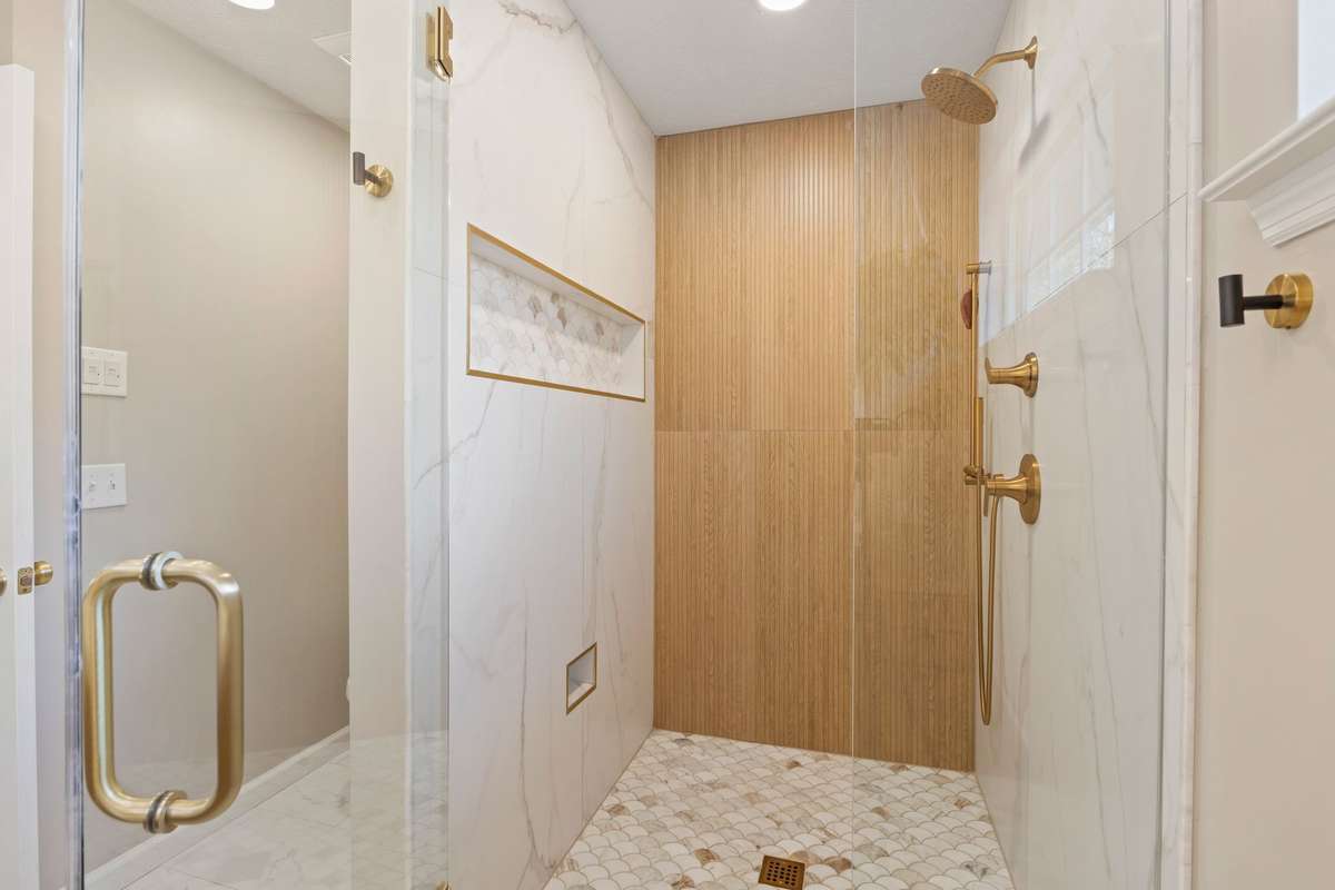Large tiled shower with marble floor