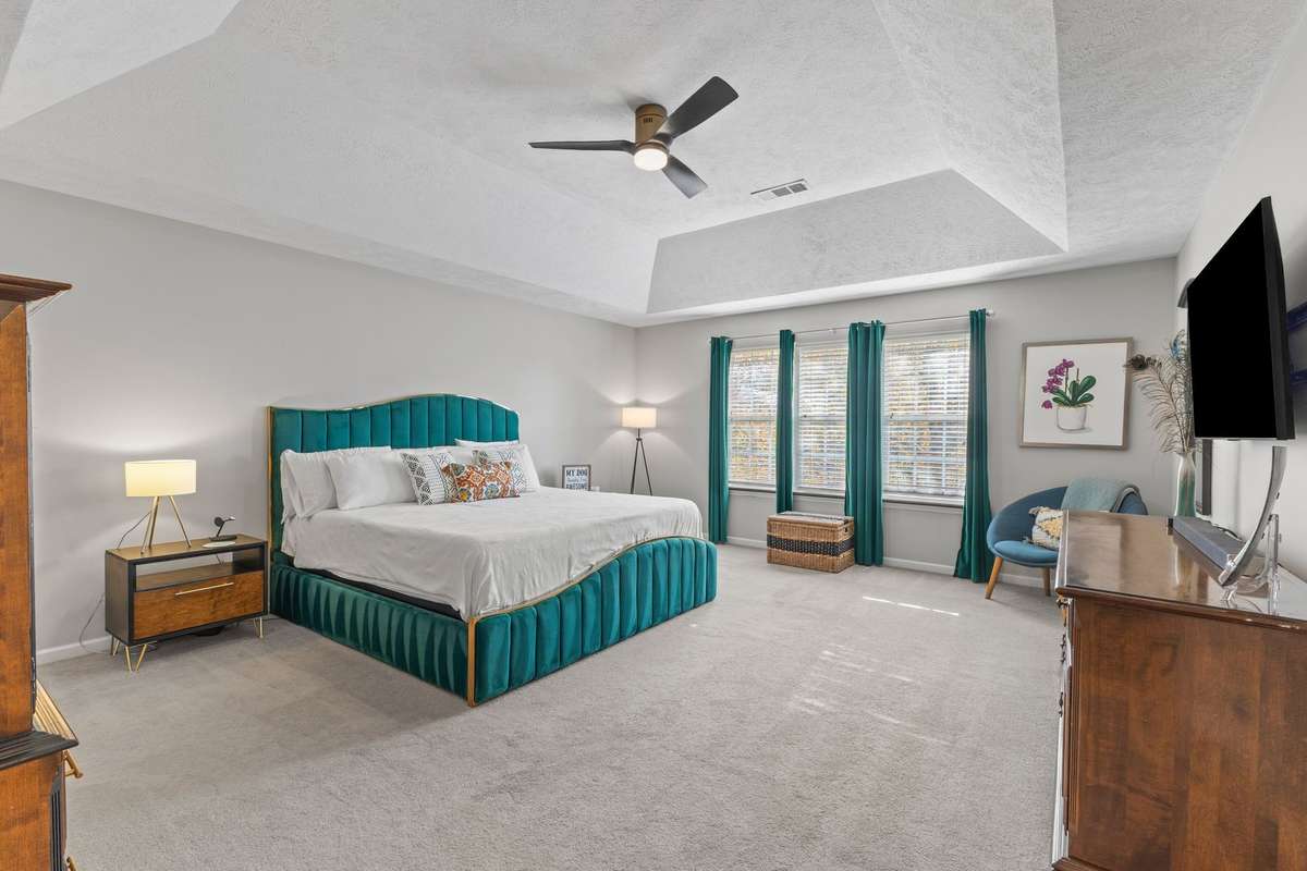 Spacious primary suite with vaulted ceiling.