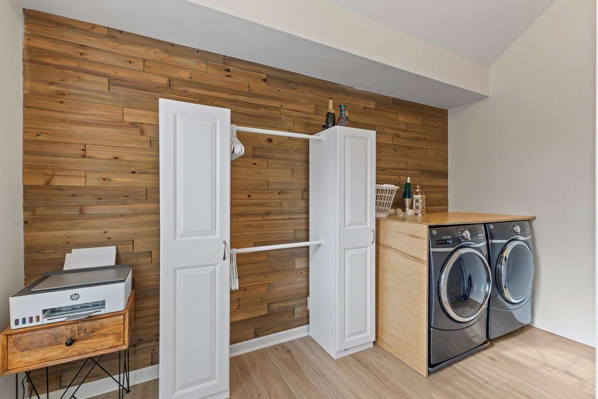 Large second floor laundry with hanging area.