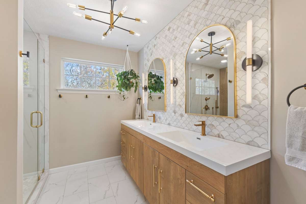 NEW Custom Primary Bath with double sink vanity, marble mermaid accent wall, and beautiful lighting and mirrors