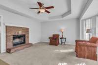 Spacious living room with cozy brick fireplace