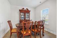 The space next to the front door is currently being used as a formal dining room; it could also function well as a home office!  The flooring has been upgraded to be consistent with the hall/kitchen/living room space.