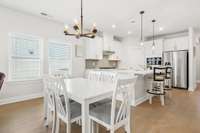 The dining space connecting the living room and the kitchen allows everyone to gather together.