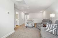 Another view of the loft, looking towards bedroom 2 at the end of the hall and stairs leading down
