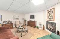 Lower level open concept living room with a cozy fireplace.  715 Pine Ridge Rd Lexington TN 38351