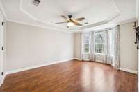 Primary bedroom w/ gorgeous bay window overlooking the backyard.