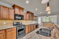 Beautiful kitchen has tons of counter and cabinet space with lighting below AND above cabinets.