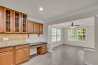 Glass front cabinets for displaying special pieces and task desk.  Wonderful sunny breakfast and dining space that overlooks private landscaped back yard.