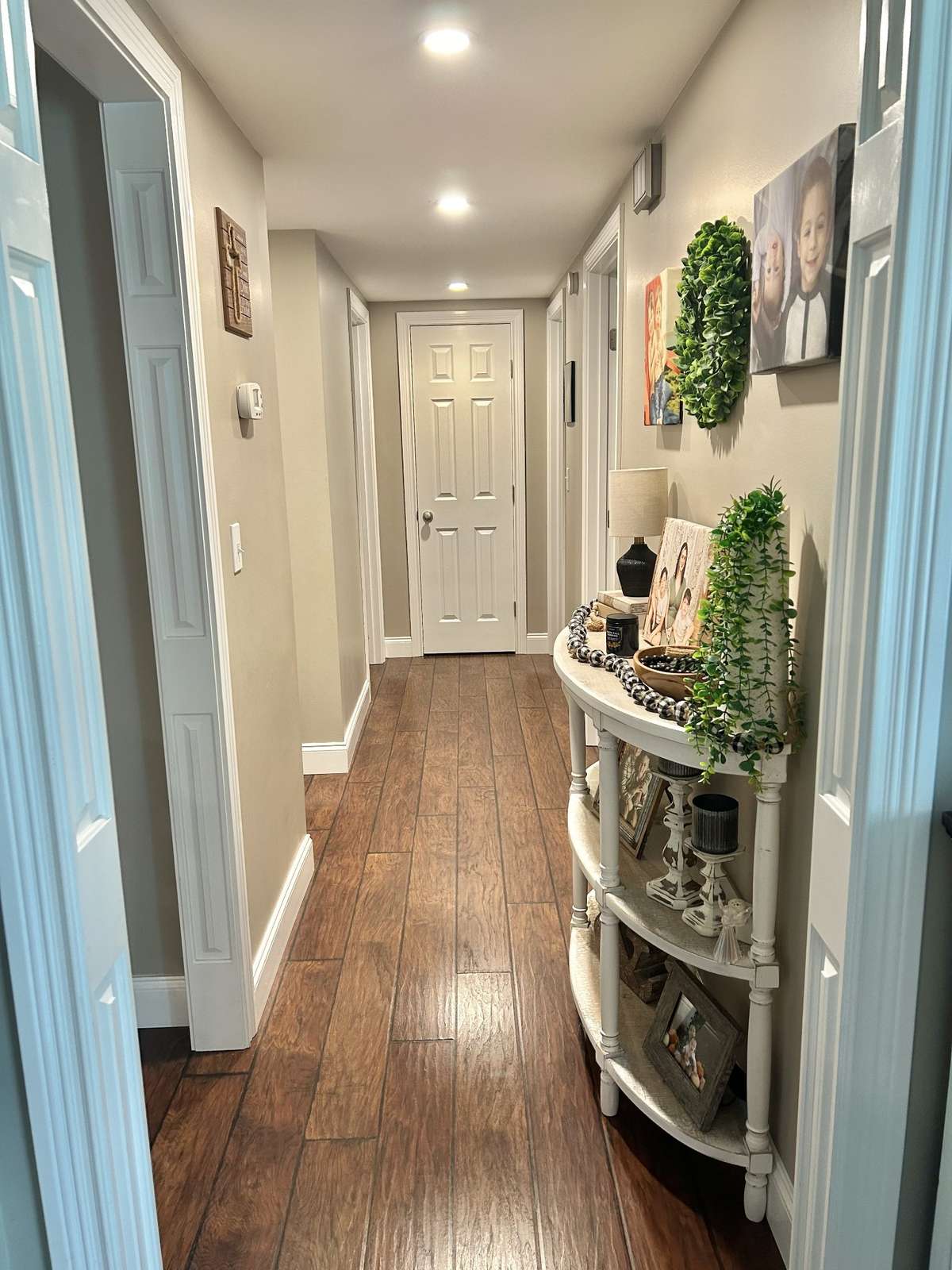 Down this hallway leads to two bathrooms and the 3 bedrooms downstairs