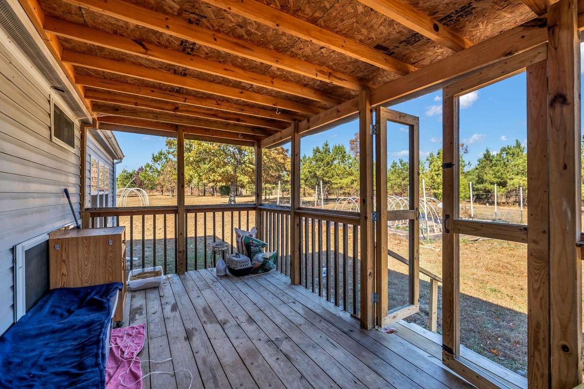 The covered back porch serves as an ideal outdoor living space, perfect for hosting events and enjoying gatherings in comfort