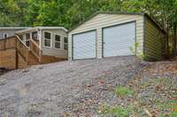 Detached two-car garage with roll-up doors.