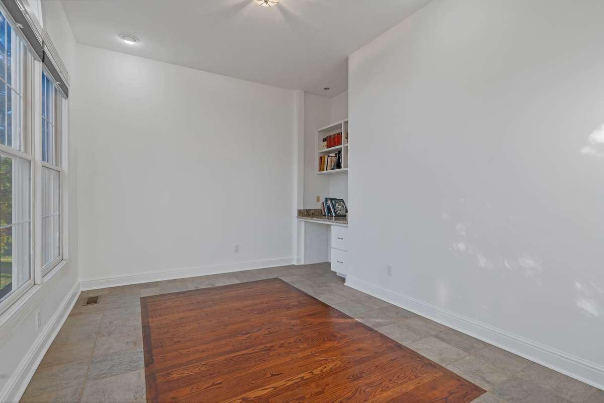 There is a fabulous nook in the corner of the office with built-in shelving, perfect for a work-from-home area.