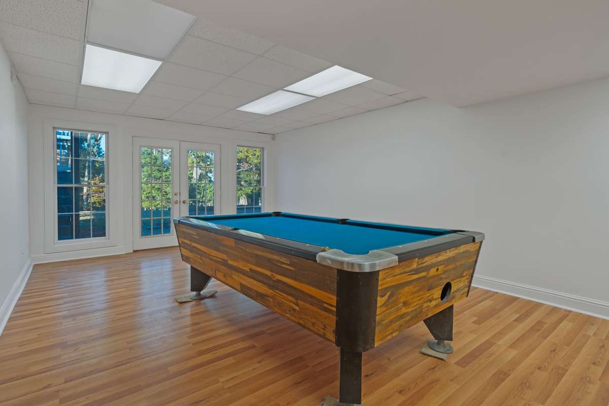 The bonus room is in the lower level just off the fourth bedroom. A set of French doors provides access to the aggregate patio.