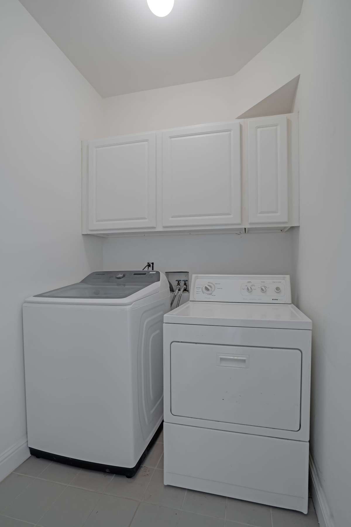 The laundry room is on the second level with three of the bedrooms. The washer and dryer convey with the sale of the home.