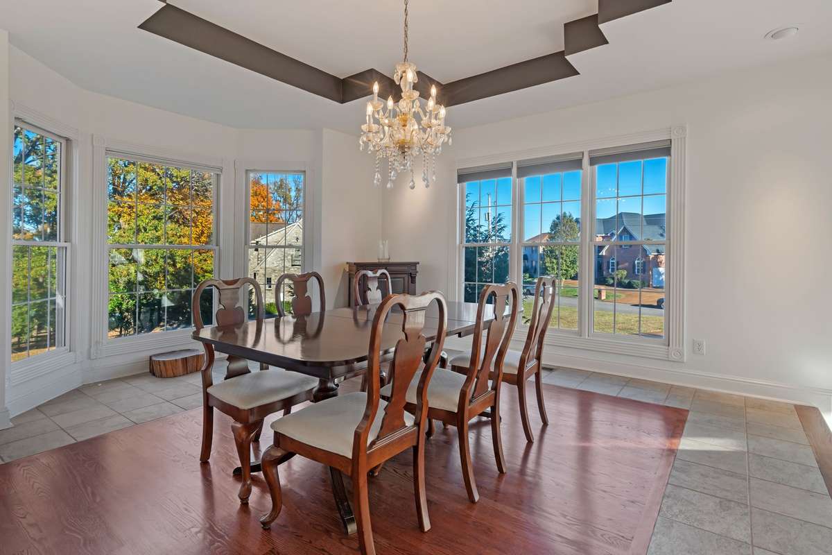 The formal dining room mirrors the brightness and decor of the living room.