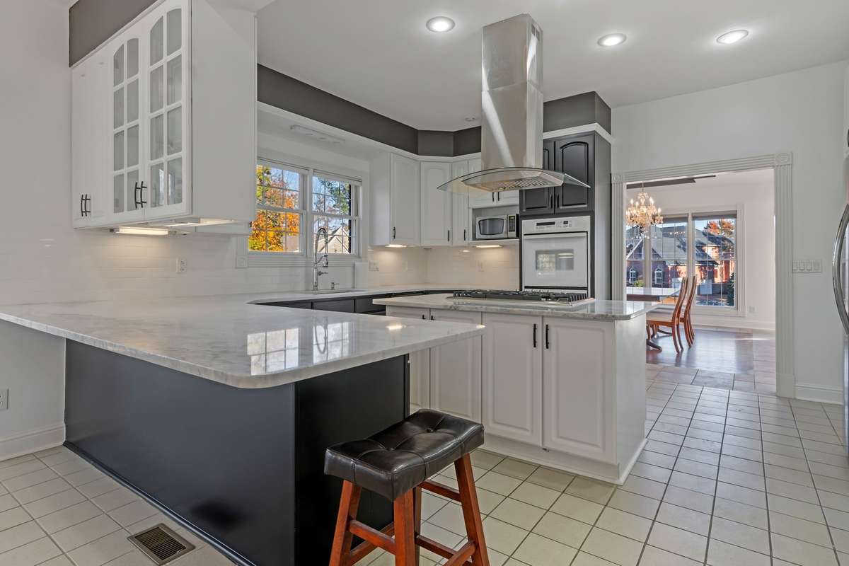 This is a reverse angle of the kitchen. The quartz counters put the final touch on the renovation. Be aware that a new stainless steel built-in oven is on order and will be installed soon.
