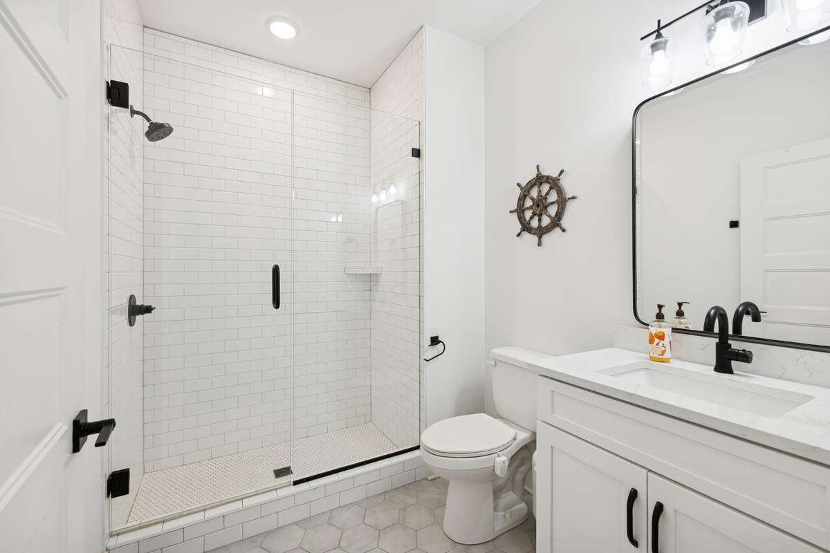 Main level bath features a walk-in shower with subway tile.