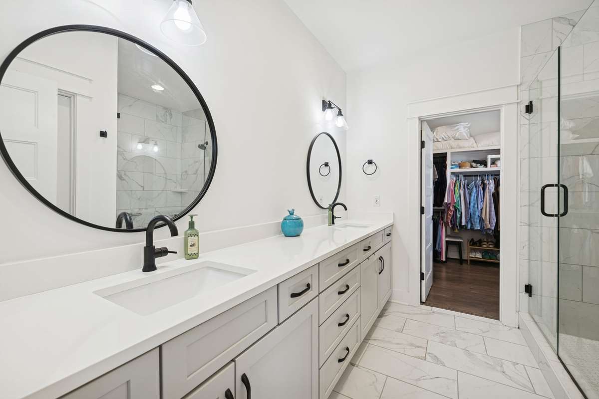 Primary bath featuring a sleek double vanity.