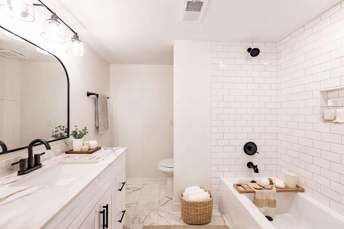 This downstair full bathroom has been completely redone. Tile, custom cabinet, porcelain tops, plumbing and electrical fixtures. 
**Ai generated/Virtually staged photo**