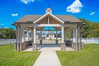 Community pavilion for gathering with friends and neighbors offers a large fenced in area for play and a cozy firepit to hang out anytime.