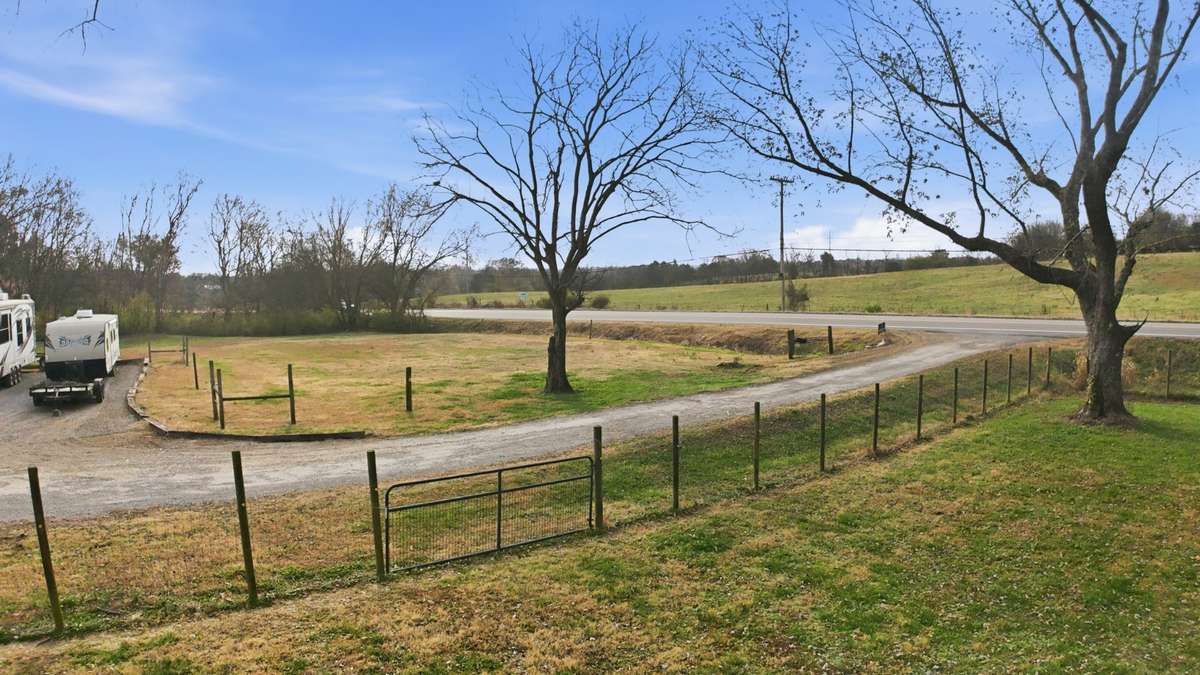 Full fenced yard in front.