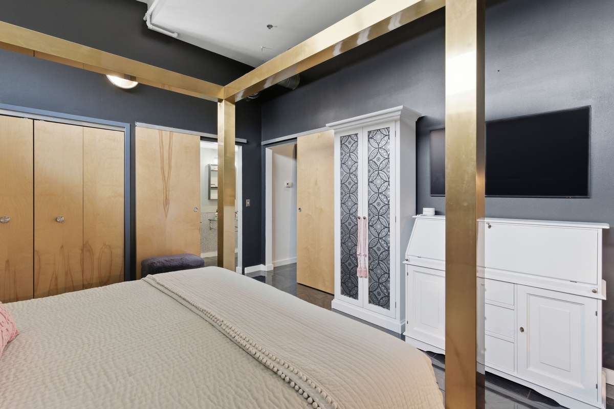 Walk-in Closet with shelving system is right through the double doors