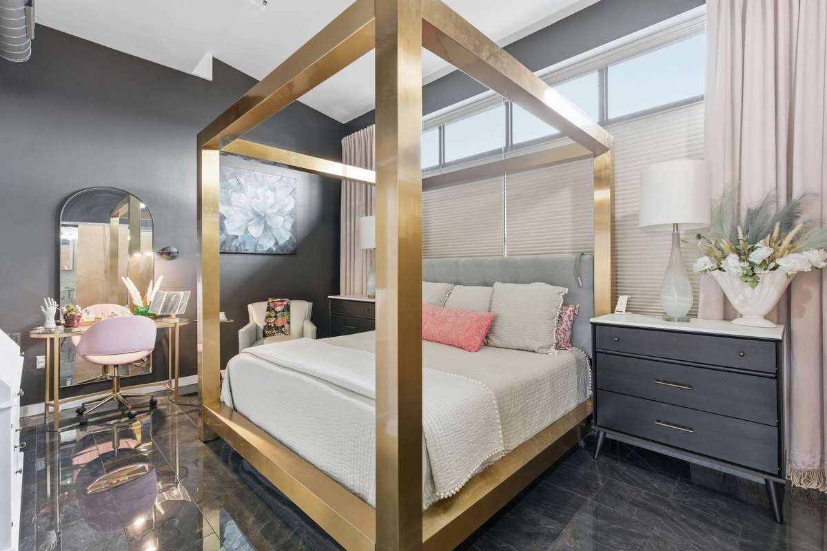 Primary Bedroom is massive with room for make-up vanity, bureaus, sitting area + four-poster bed. Vaulted ceilings + another wall of windows!