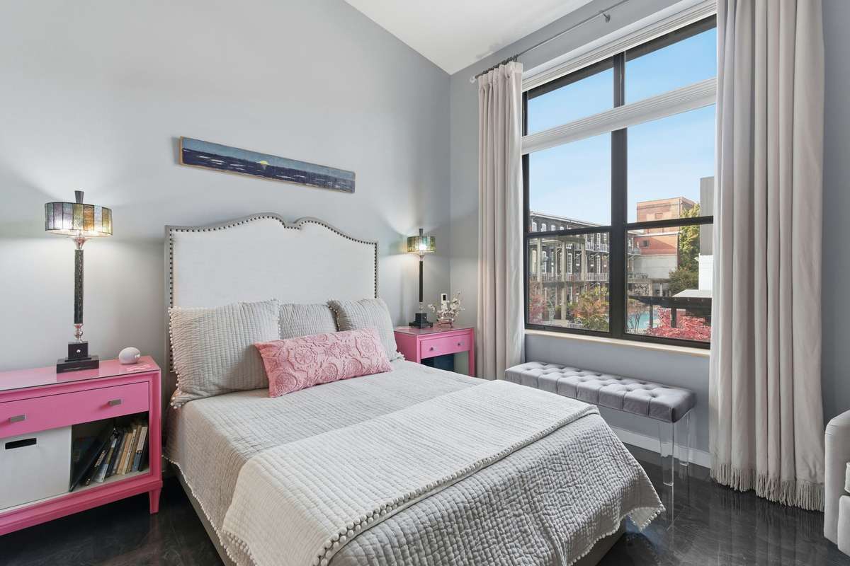 Second Bedroom overlooks the stunning grounds of Werthan Lofts + also offers vaulted ceilings