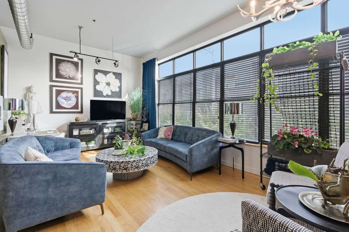 Living Room is framed by a wall of windows + the exposed ductwork Werthan is known for!