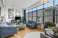 Living Room is framed by a wall of windows + the exposed ductwork Werthan is known for!