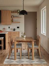 The dining set was carefully crafted from a white oak tree previously on the property that was milled onsite, seasoned, kiln-dried, and transformed into a staple of this home.